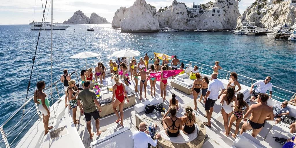 Yacht party at 38-Foot Cabo Party Boats With Optional Pole Dancing Classes with rock formations, sunny day