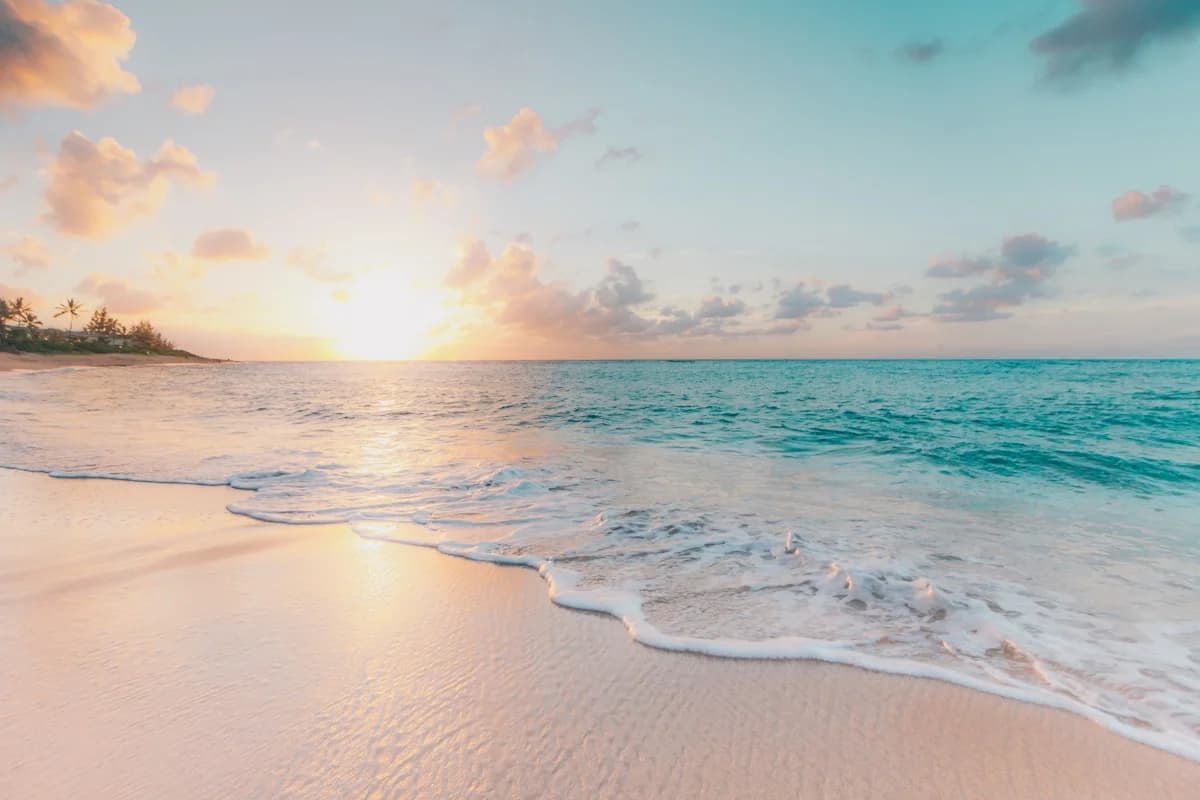 Beach sunset at 5-Day Cabo Vacation Packages vs 3-Day Vegas Trip Costs gentle waves, soft light, tranquil