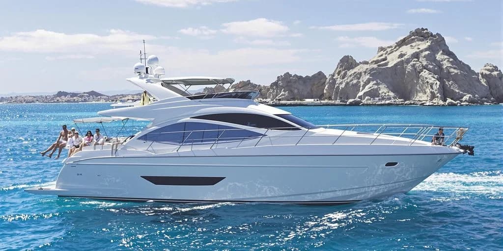Luxury yacht at 55' Sunseeker Yacht Charters in Cabo for $2,499 (4 Hours, 12 People) on blue water, rocky coastline