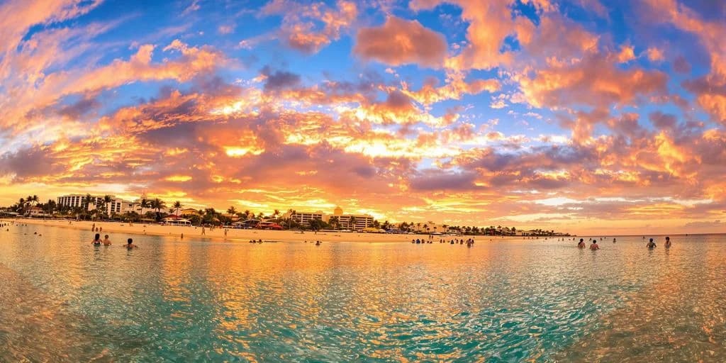 Beach sunset at Cabo Mexico On A Budget: What You Need to Know with resort buildings, calm water