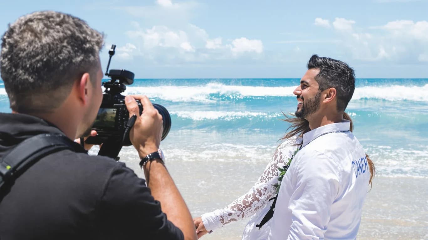 Beach photography at Cabo Photography Services That Include Same-Day Previews person holding camera, ocean waves