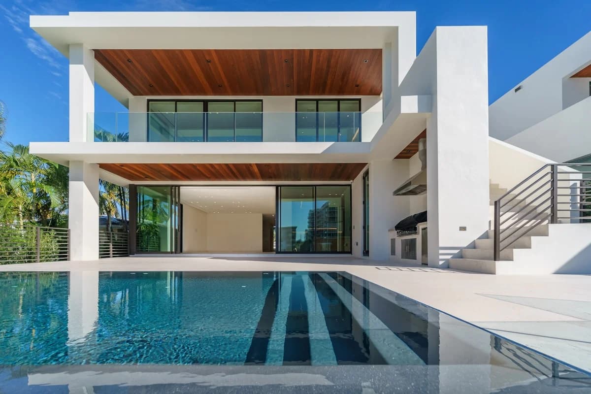 Modern house exterior at Cabo San Lucas Beachfront Villa: Your Ultimate Luxury Escape with pool and glass doors