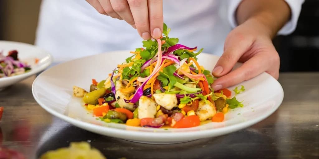 Plated salad at Cabo Villa Chef Service: Baja-Mediterranean Fusion Cuisine hand garnishing with herbs