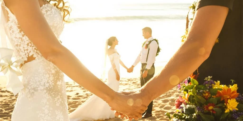 Wedding couple at Cabo Wedding Venues That Include Judge, Flowers & Photographer holding hands on beach