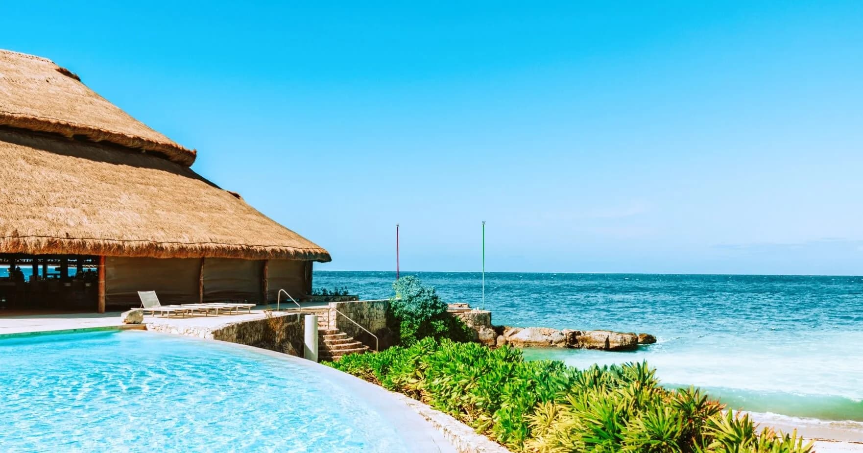 Poolside ocean at Cabo San Lucas: How to Plan Family Vacations and Truly Enjoy the Baja Dream with steps, green foliage
