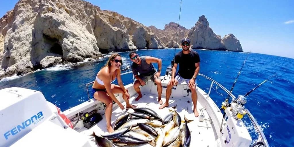 Fishing boat at Ultimate Guide to Deep Sea Fishing in Cabo people with catch, rocky coast