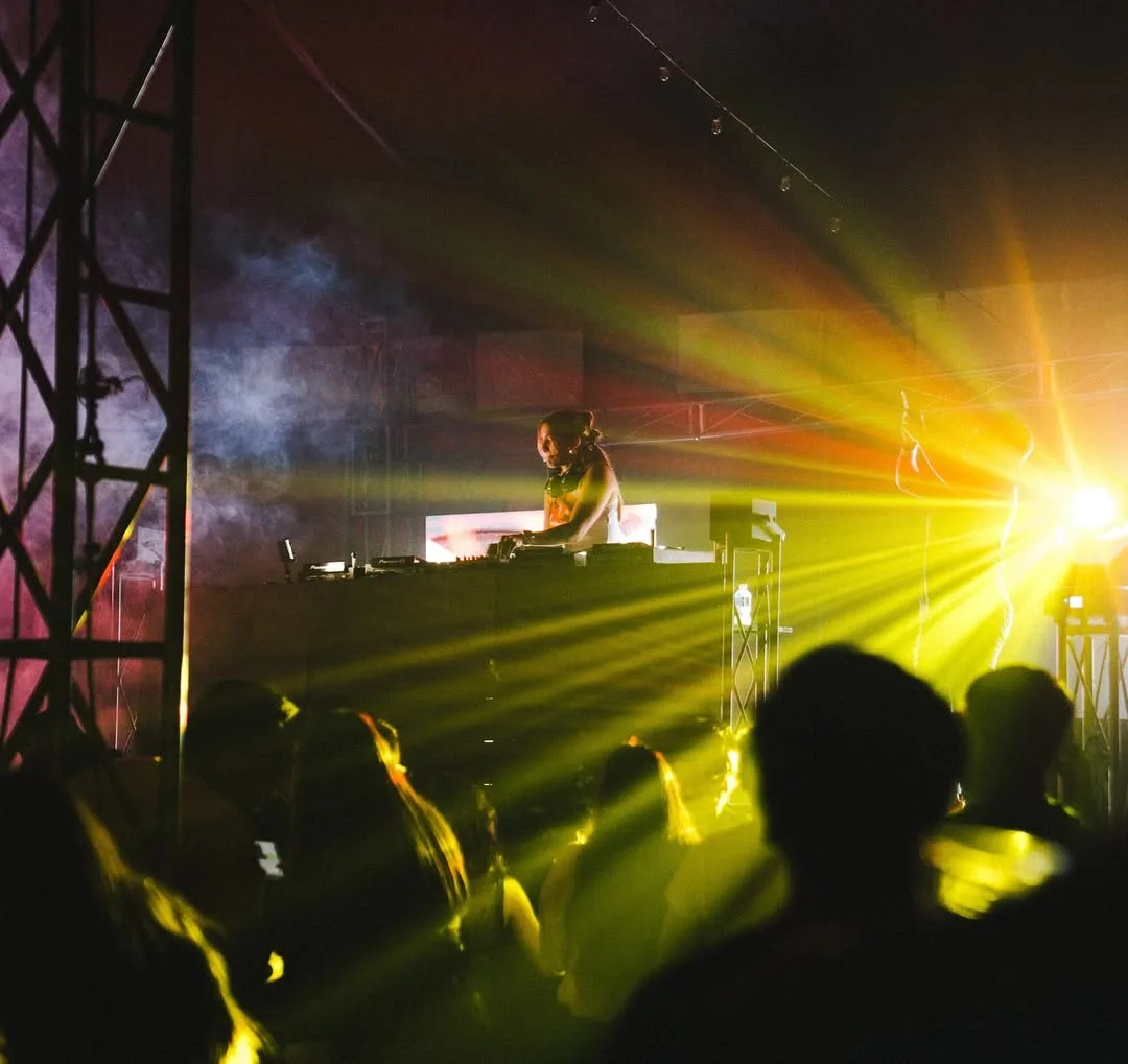 Dj performance 2 at Private DJ Experience man, yellow light beams, crowd in Los Cabos