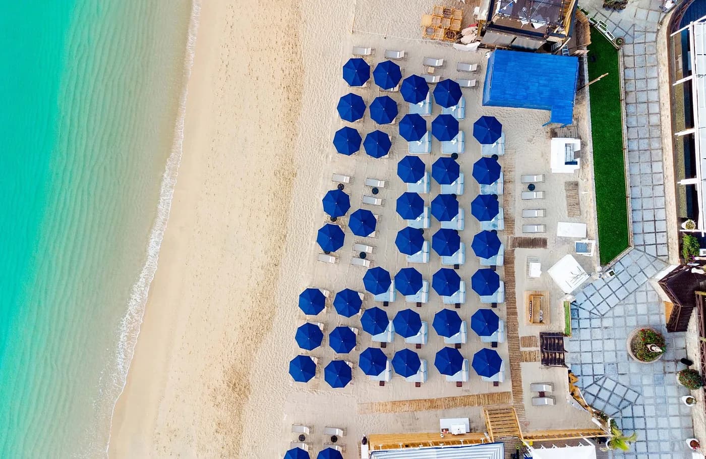 Beach umbrellas at Your Next Cabo Escape: Decoding the New $25 Tourist Tax for Los Cabos aerial view, on sand