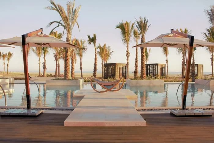 Pool area at Private Pilates Session with palm trees, at sunrise in Los Cabos