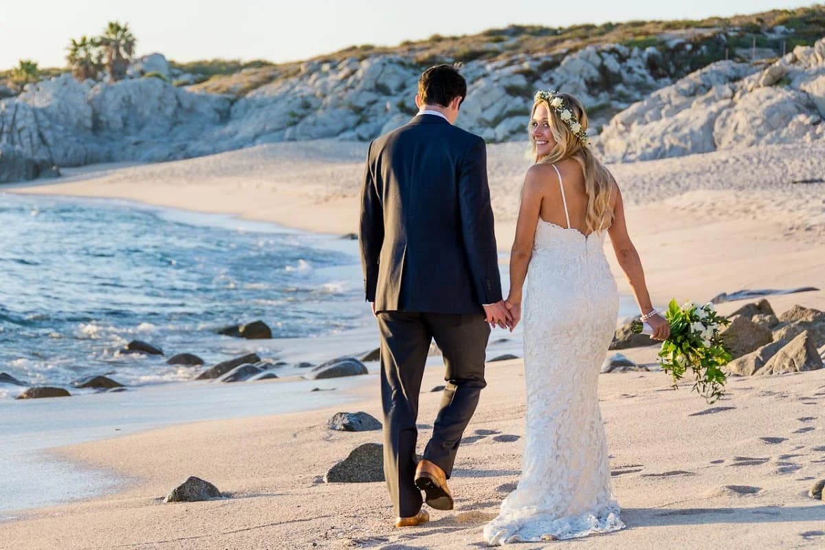 Beach wedding couple 2 at Professional Photographer walking hand in hand, ocean in Los Cabos