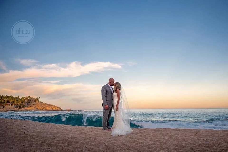 Beach wedding couple 4 at VIP Engagement Proposal kissing at sunset, ocean waves in Los Cabos
