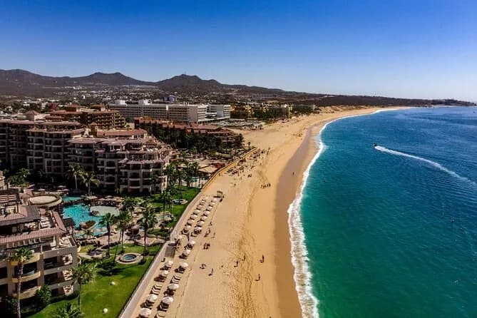 Beach aerial at Private Surf Lesson with resort buildings, sunny day in Los Cabos