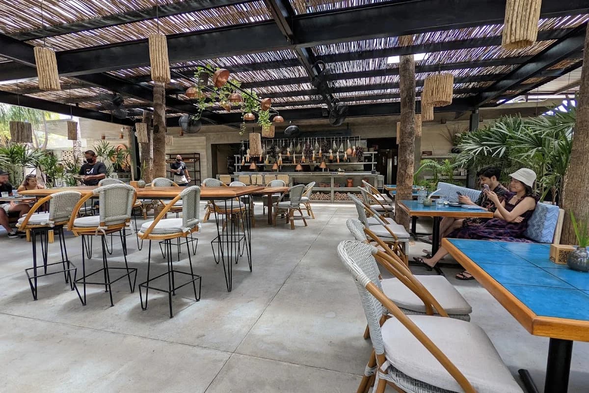 Outdoor restaurant at Acre Restaurant with open kitchen, woven ceiling in San José del Cabo