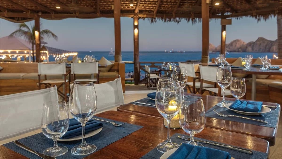 Outdoor dining at Aleta at dusk, with ocean beyond in Cabo San Lucas