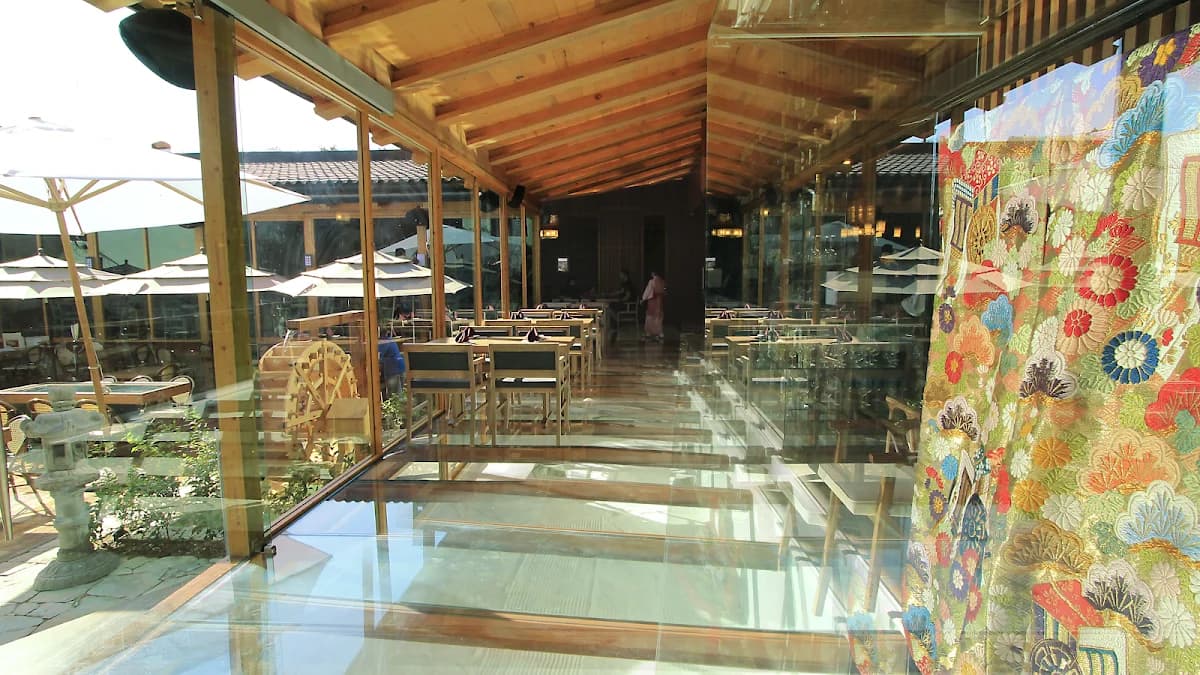 Indoor restaurant at Daikoku with glass floor, wooden ceiling in Cabo San Lucas
