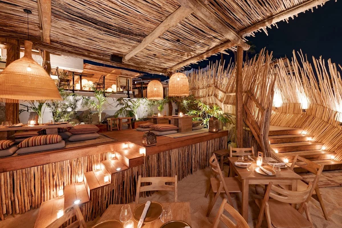 Outdoor lounge at Funky Geisha with woven roof, ambient lighting in Cabo San Lucas