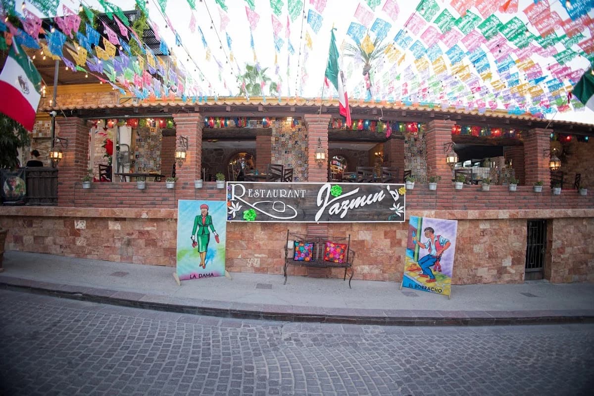 Restaurant exterior at Jazmin's Restaurant with colorful flags, street view in San José del Cabo