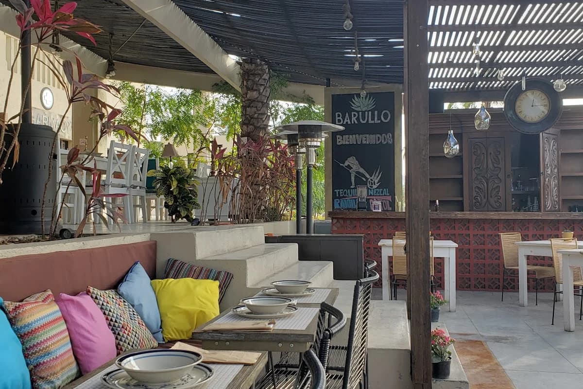 Outdoor dining area at La Osteria with heater, chalkboard menu in San José del Cabo