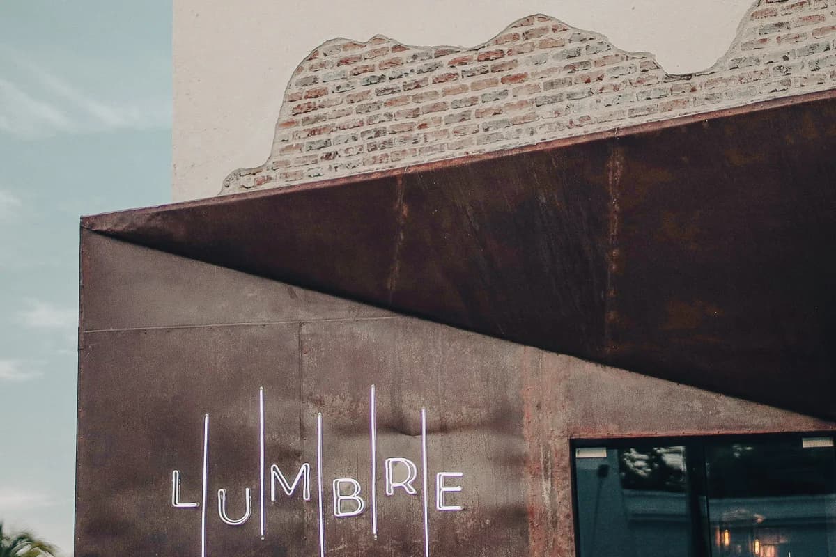 Building facade at Lumbre brick and metal, neon letters in San José del Cabo