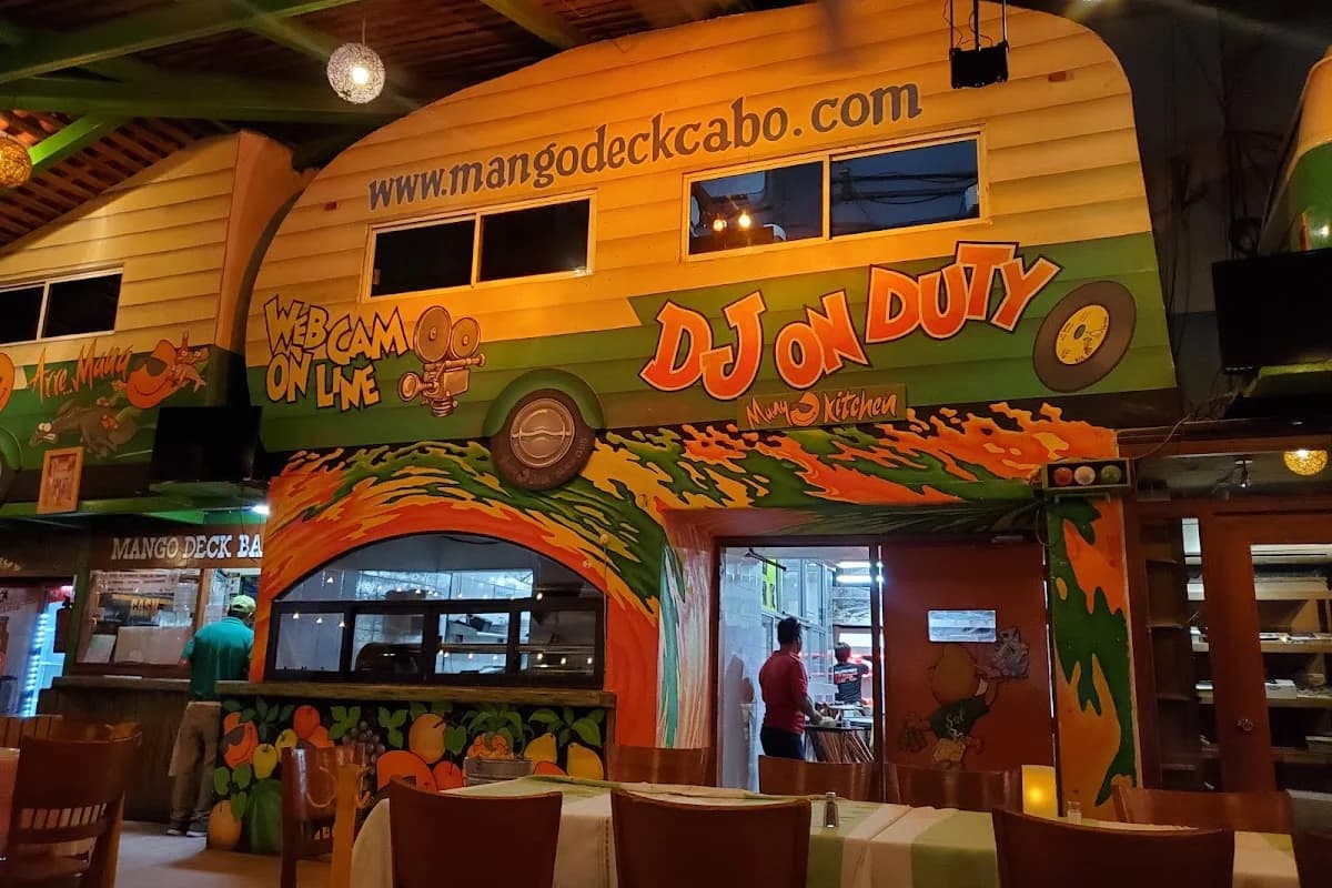 Restaurant exterior at Mango Deck colorful mural, bus theme