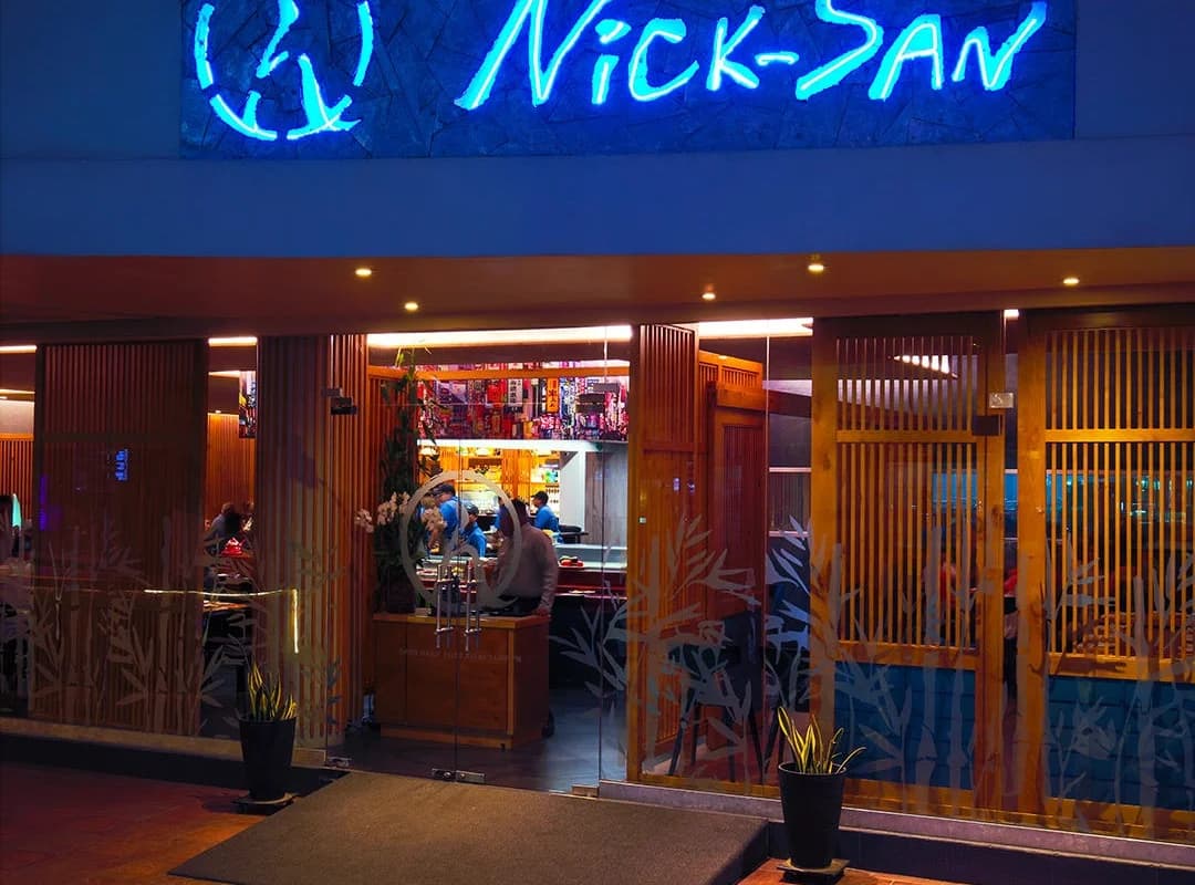 Restaurant entrance at Nicksan Cabo neon sign, glass doors in Cabo San Lucas
