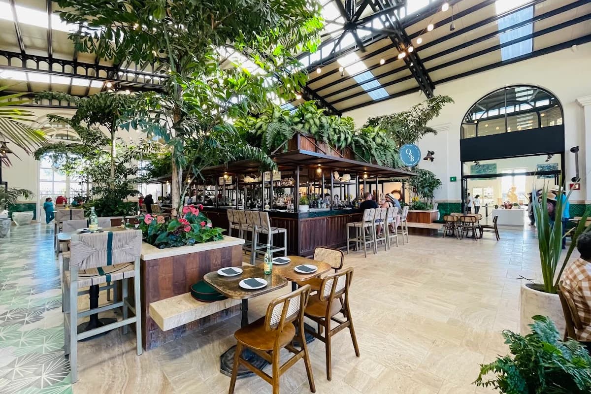 Indoor bar at Oystera lush greenery, high ceiling in Todos Santos