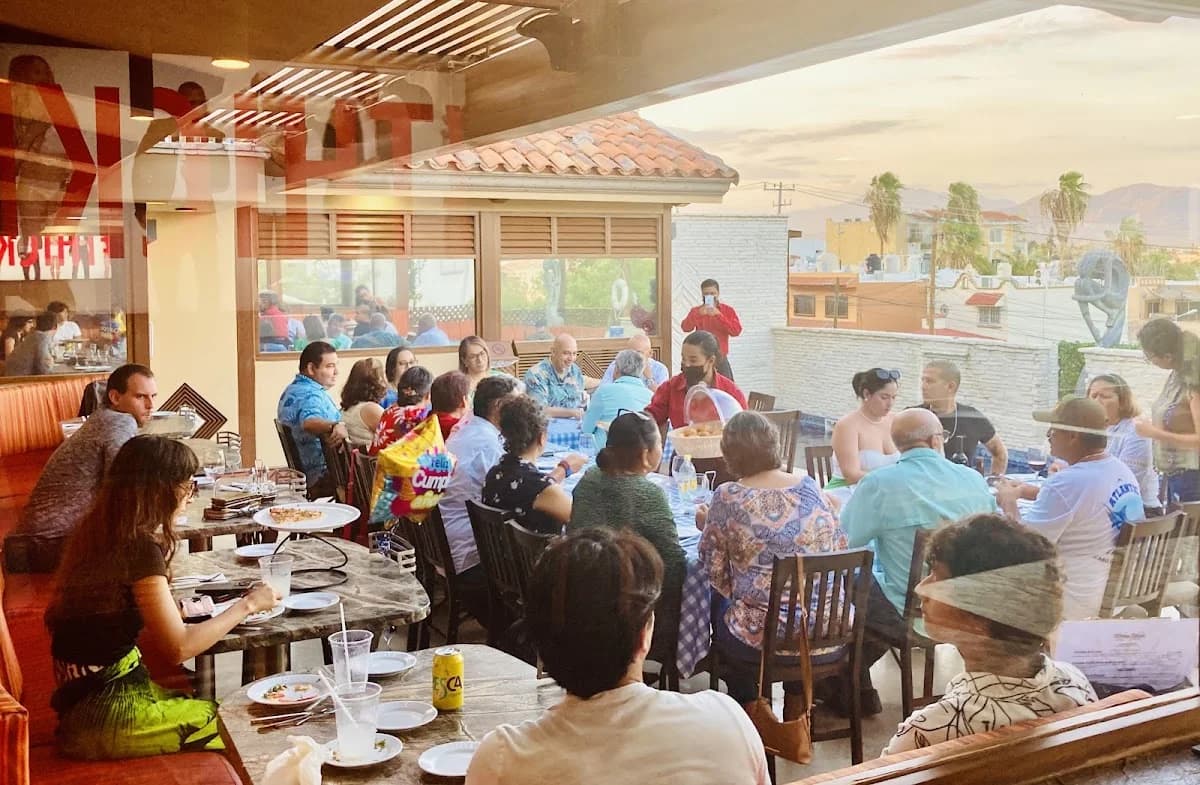 Group dining at San Lucero Restaurant & Wine Bar people at a long table, daytime in Cabo San Lucas