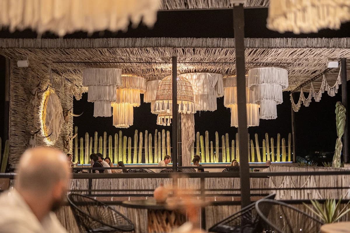 Restaurant interior at Santoro decorative ceiling, people dining in Todos Santos