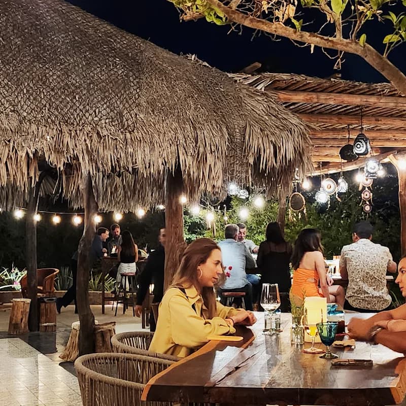 Outdoor bar at Tamarindos at night, with string lights in San José del Cabo