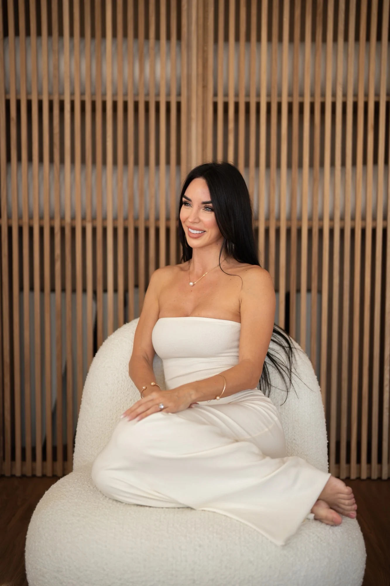 Danielle Paré, founder of Senses, seated in a white dress