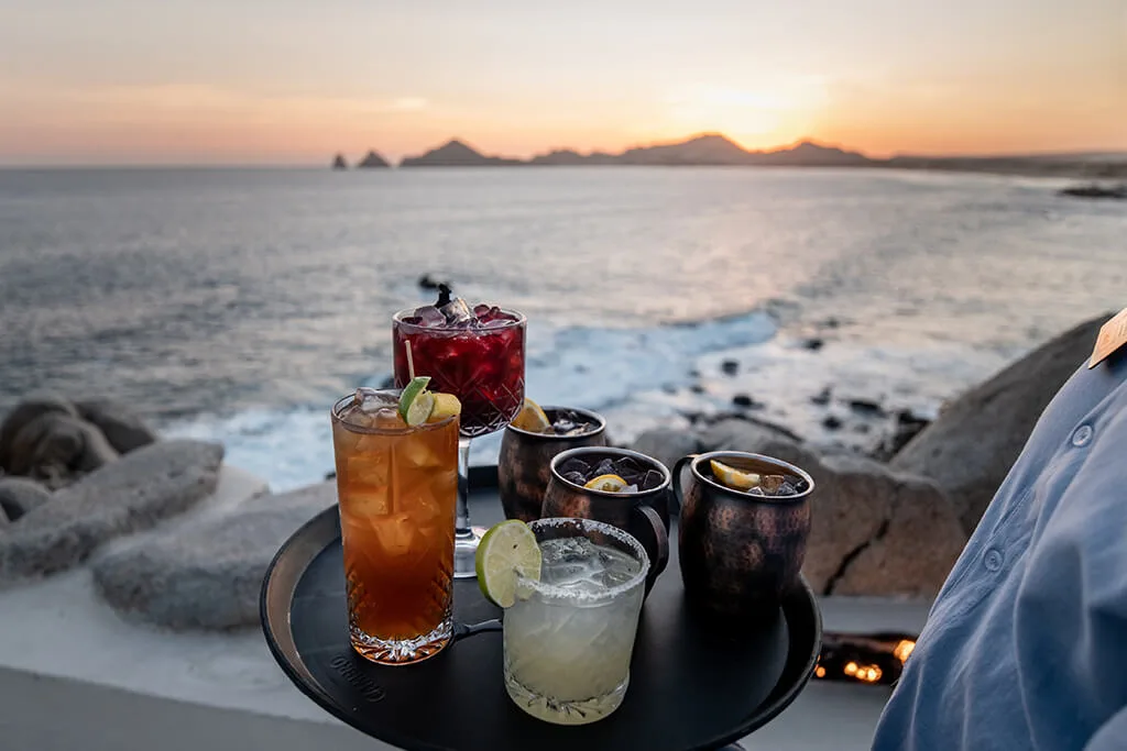 Cocktails at sunset at Private Bartender & Mixology with ocean and mountains beyond in Los Cabos