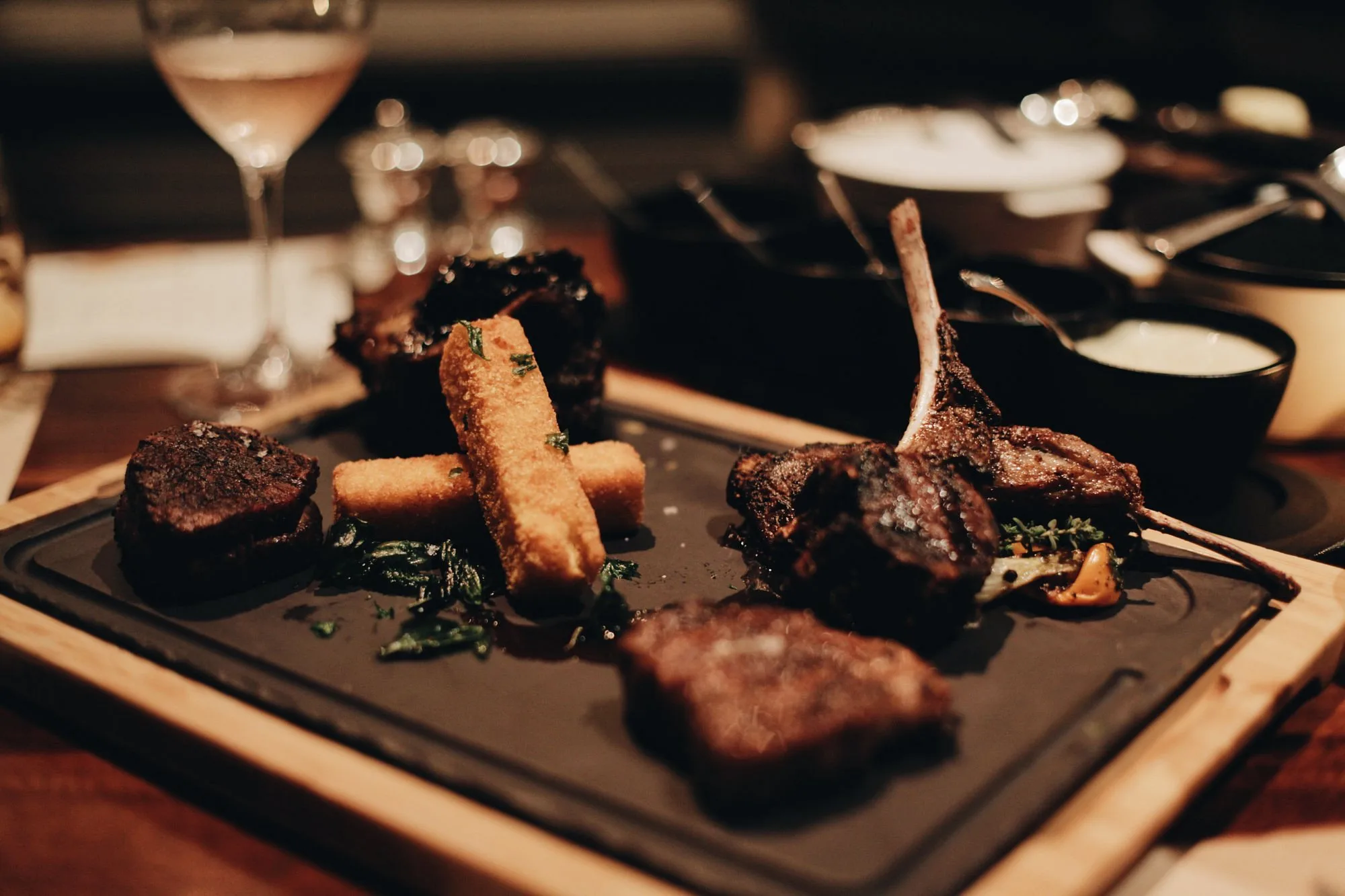 Plated food at Wine & Tequila Sommelier Experience close-up, dark setting in Los Cabos