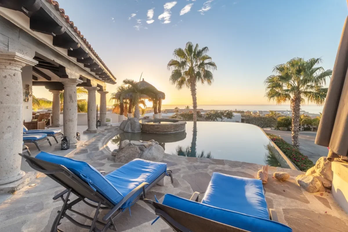 Infinity pool 4 at Casa Corona with lounge chairs, at sunset in Cabo Del Sol