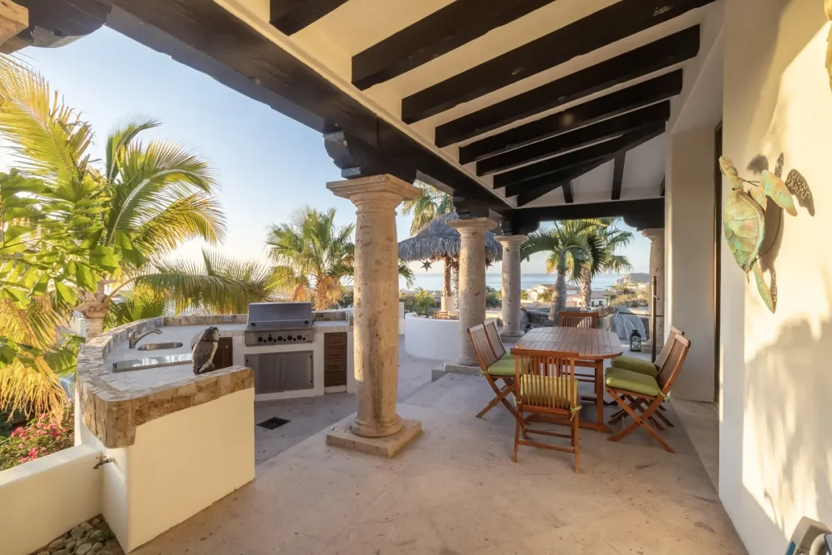 Outdoor patio at Casa Corona with grill, ocean in distance in Cabo Del Sol