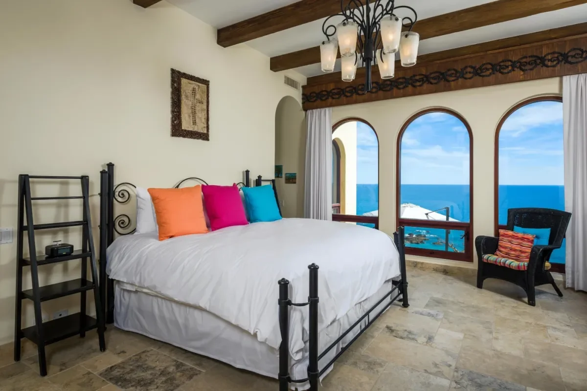 Bedroom 1 at Bella's 2026 Guide: Your Perfect Cabo Daily Yacht Rental Experience with colorful pillows, ocean view