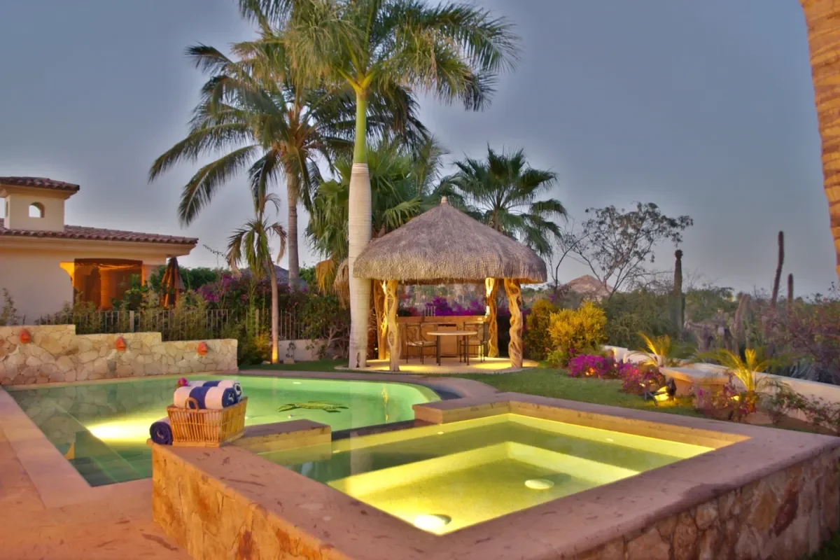Palapa bar at Casa Tortuga next to pool, lit at night in Cabo Del Sol