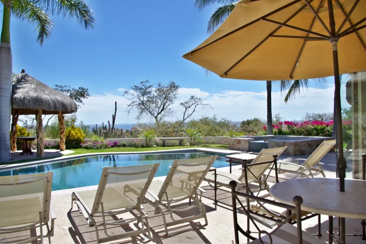 Swimming pool 2 at Casa Tortuga with lounge chairs, ocean beyond in Cabo Del Sol