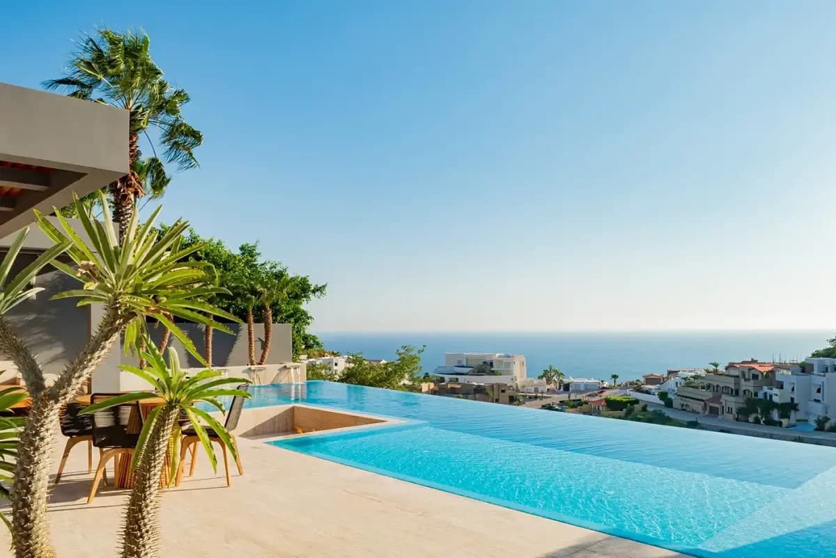 Infinity pool at Maison De Cortes with ocean beyond, clear sky in Pedregal Pacific