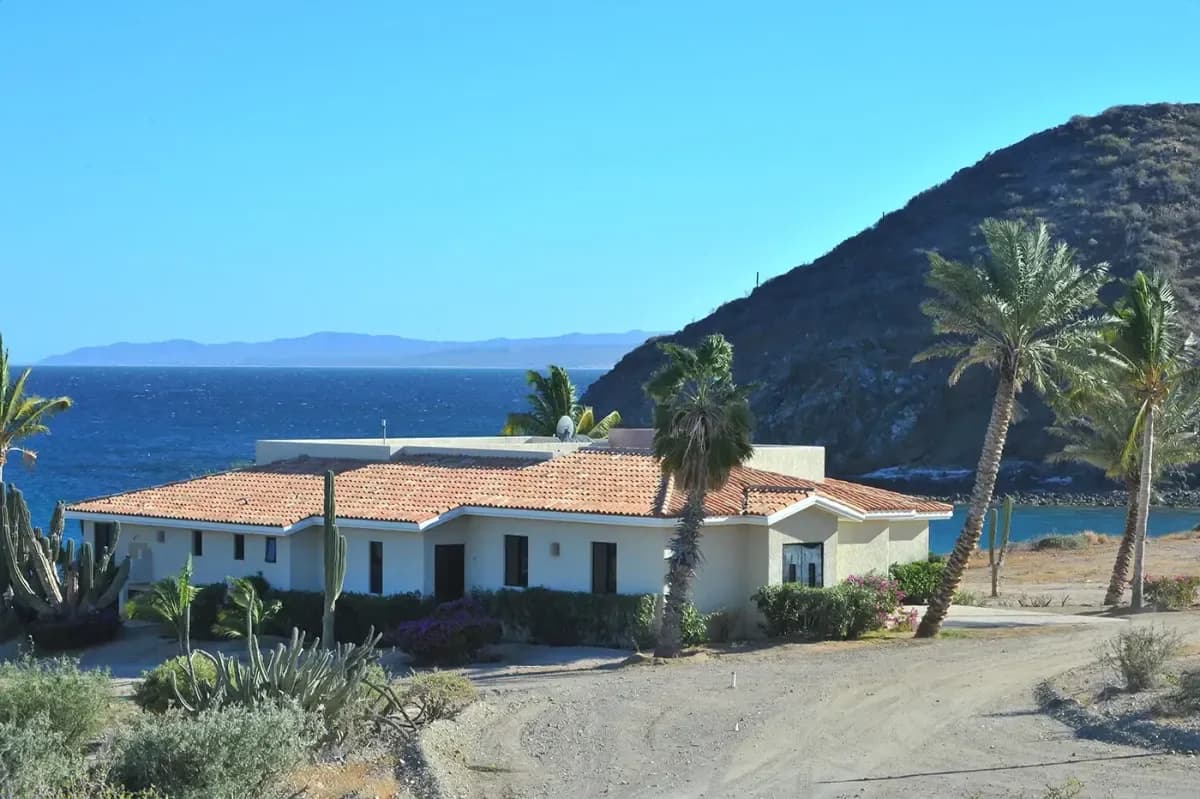 Exterior facade at Best Villas for Your Bachelorette Party in Cabo San Lucas 2026 with ocean and mountains beyond