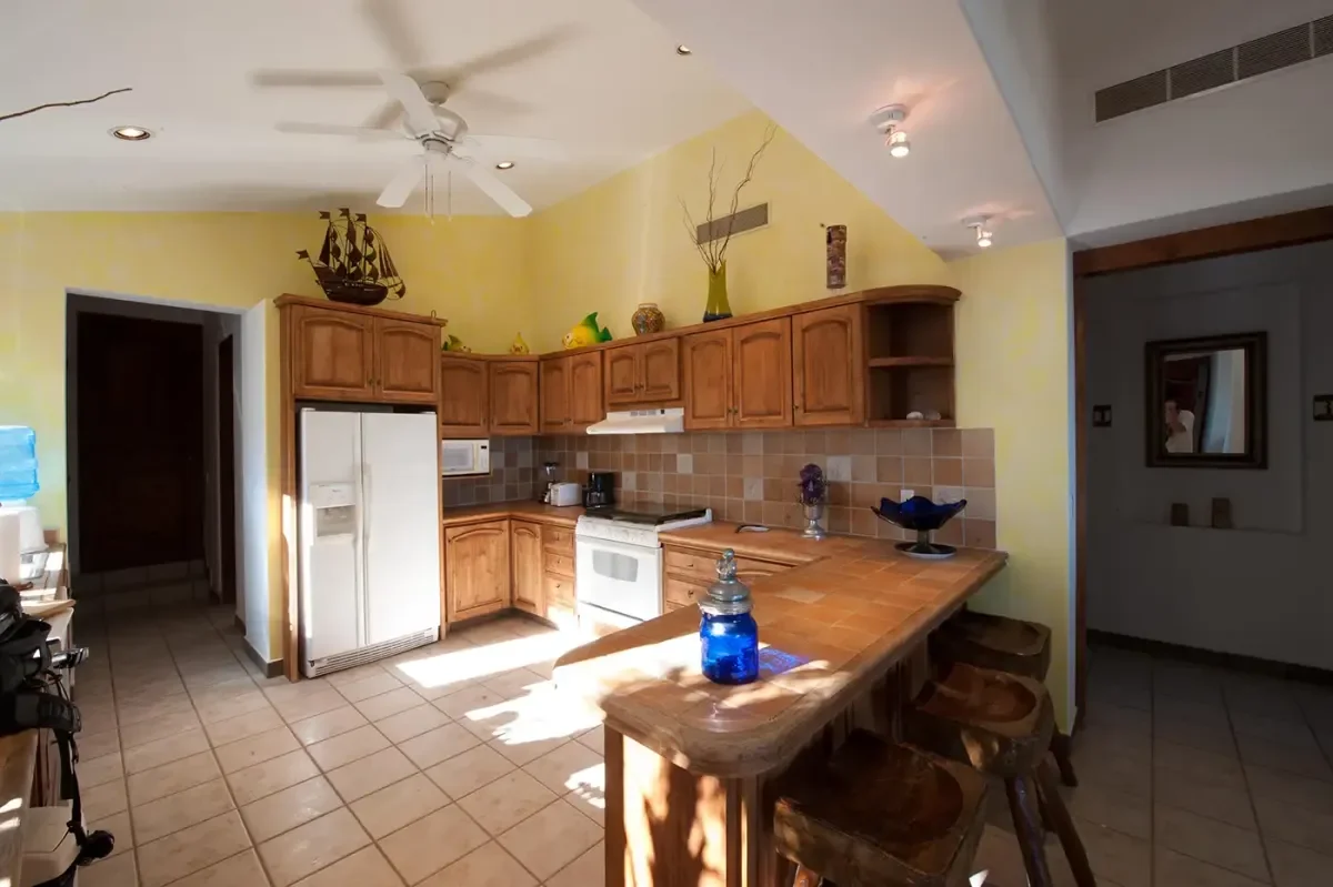 Open kitchen 1 at Lovers Beach Swimming with wooden cabinets and island