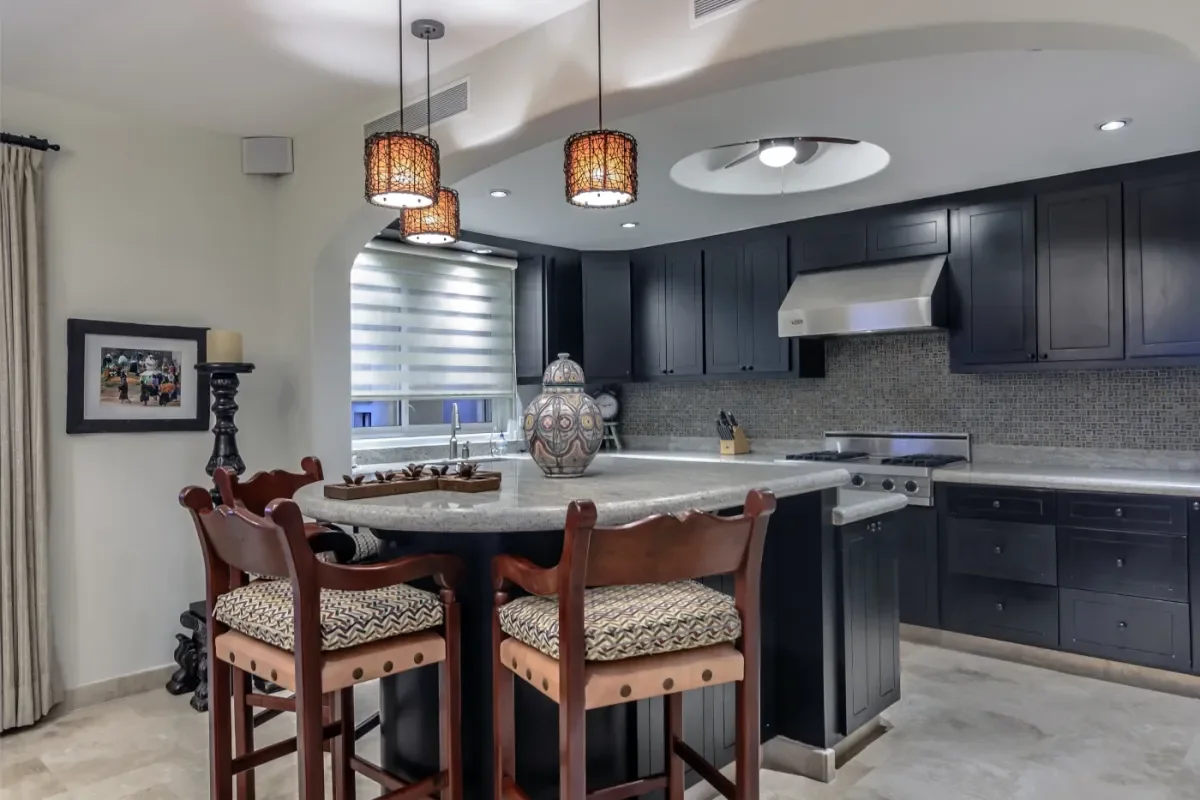 Kitchen bar at Experience Ultimate Opulence: Your 2026 Cabo Millionaire Guide with bar stools, pendant lights