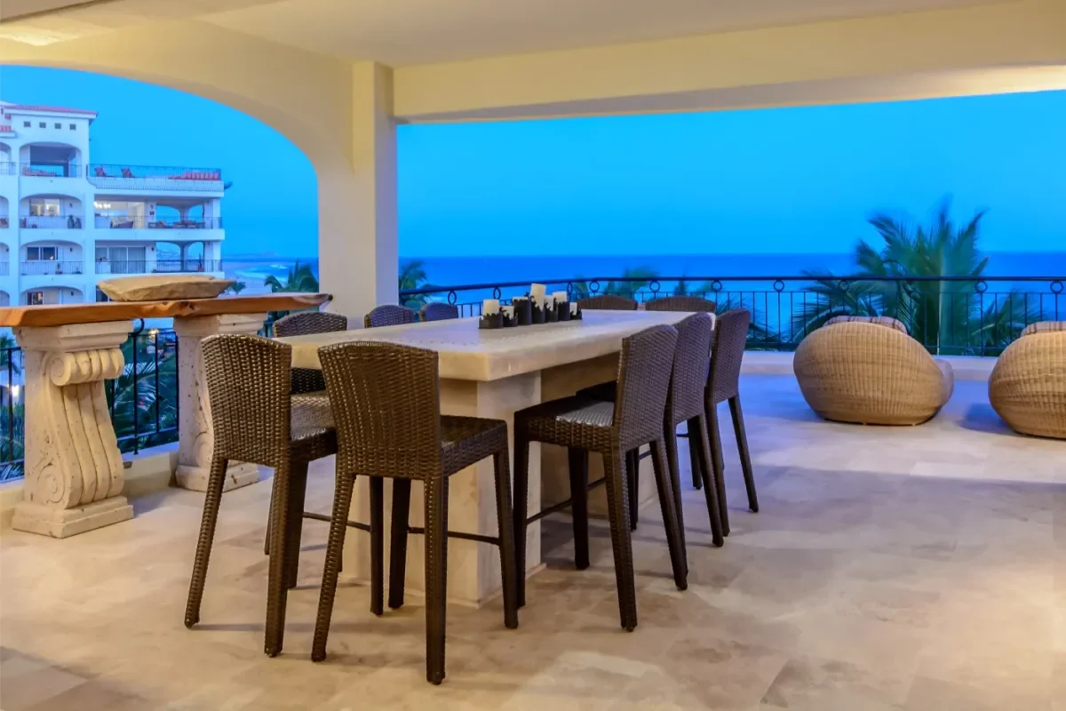 Outdoor dining at Can You Swim At Lovers Beach with ocean view at dusk