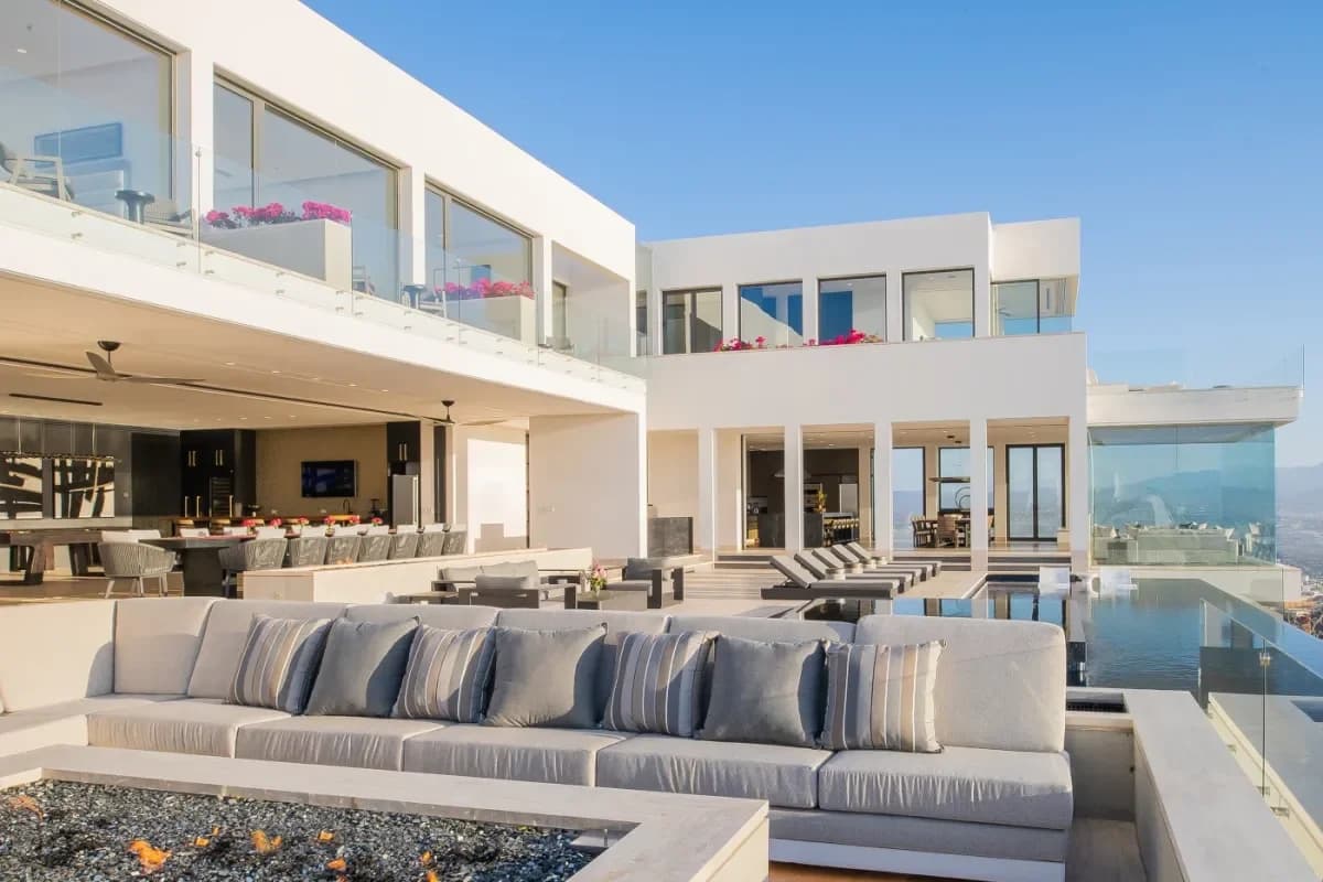 Outdoor lounge at Experience Unrivaled Ease: Luxury Concierge Services in Cabo San Lucas 2026 with fire pit and white
