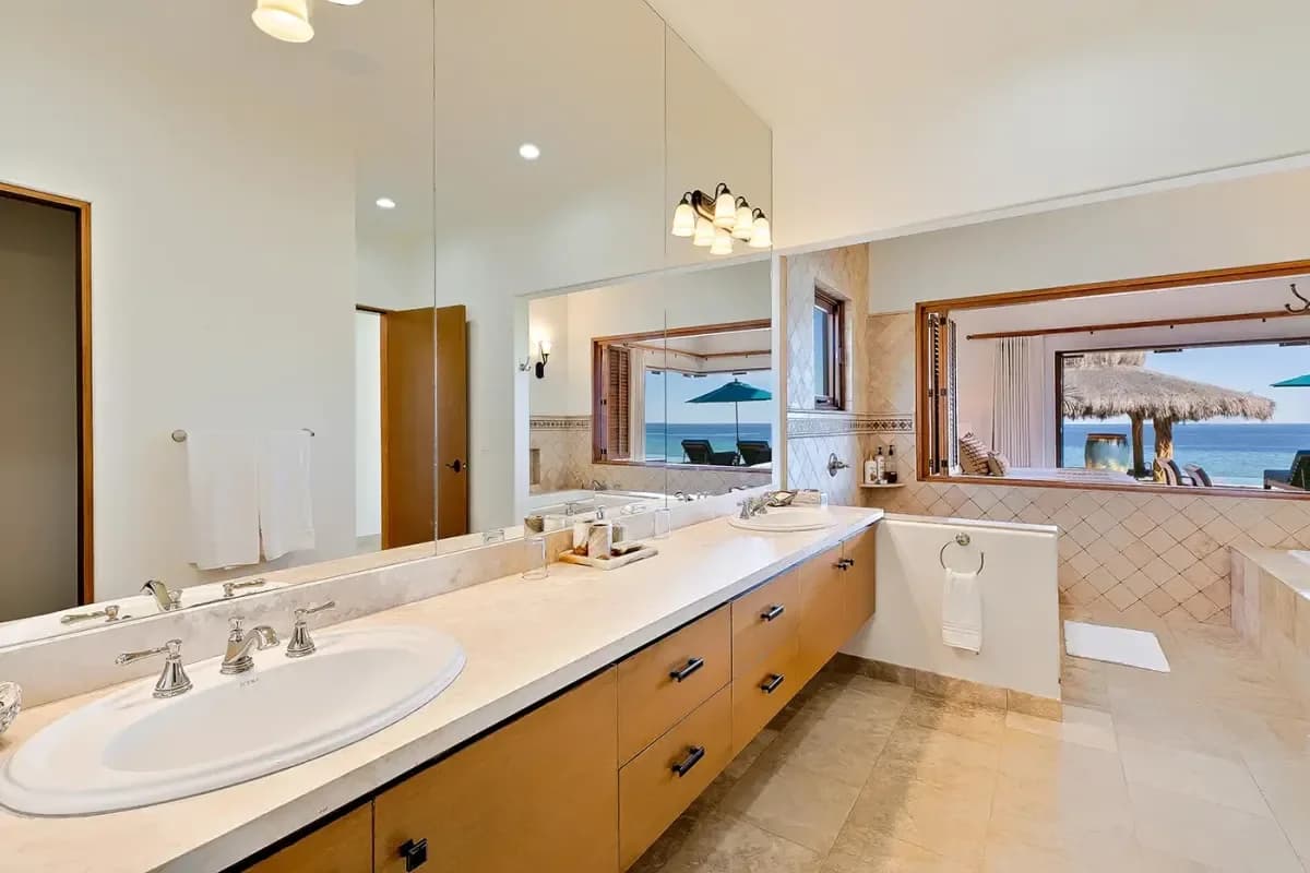 Bathroom vanity at Cabo San Lucas vs. Tulum: 2026 Real Estate Investment Comparison with mirror reflecting ocean view