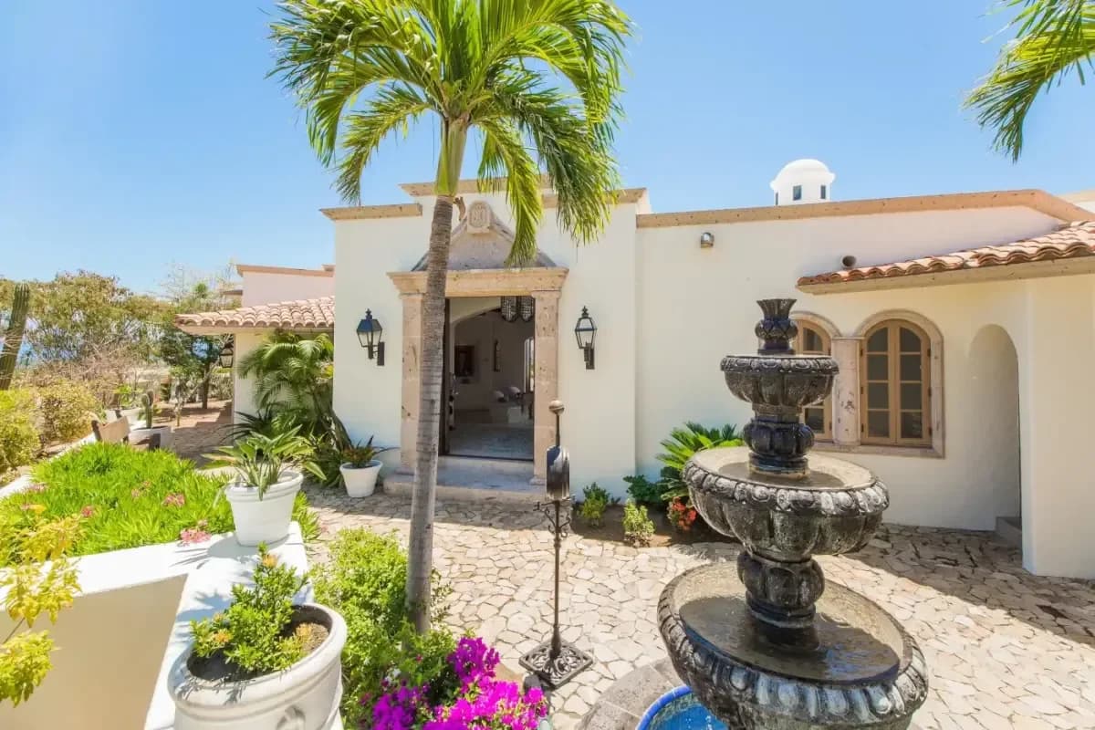 Main entrance at Villa Buena Vida with palm tree and fountain in Cabo Del Sol