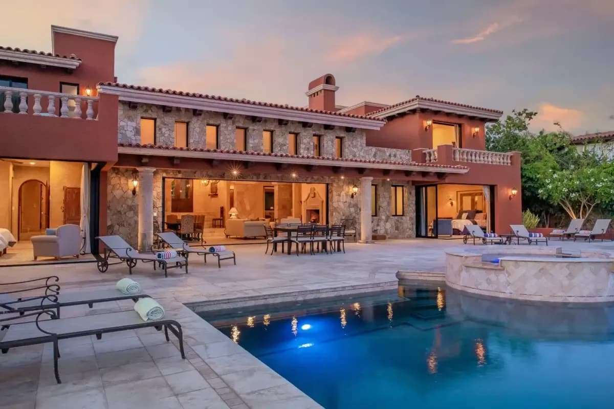 Exterior facade 2 at Discover Unrivaled Luxury: Beachfront Villas Cabo San Lucas for 2026 with lit pool, at dusk