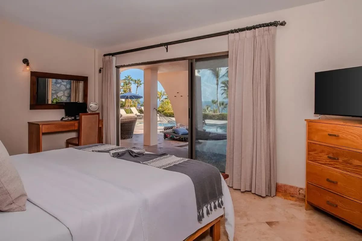 Bedroom with view at How Much Does it Cost to Rent a Villa in Cabo in 2026? Your Guide with patio and ocean beyond