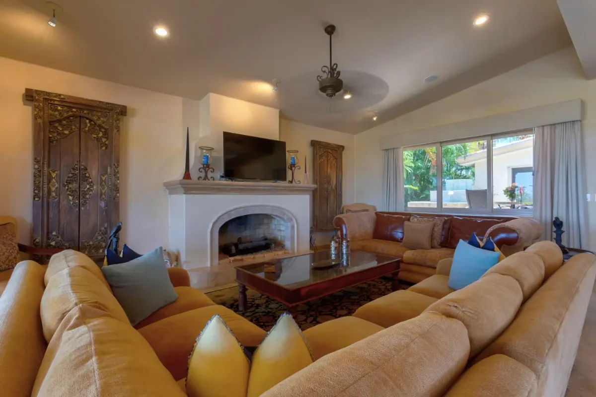 Living room 1 at Villa Esquina with fireplace and television in Cabo Del Sol