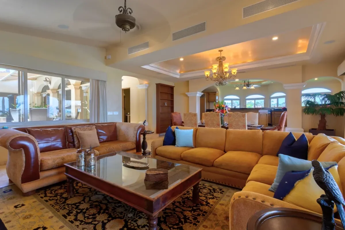 Living room 3 at Villa Esquina with chandelier and bookshelf in Cabo Del Sol