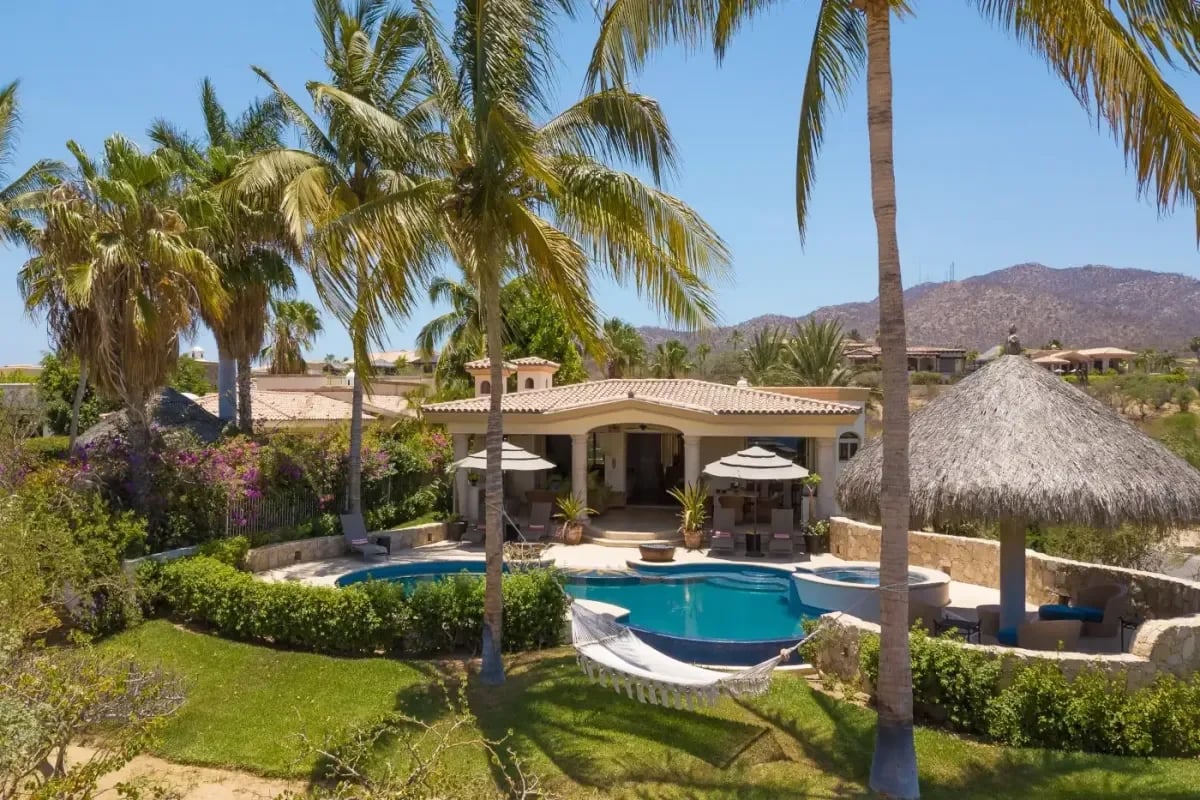 Pool area at Villa Esquina with palm tree, hammock in Cabo Del Sol